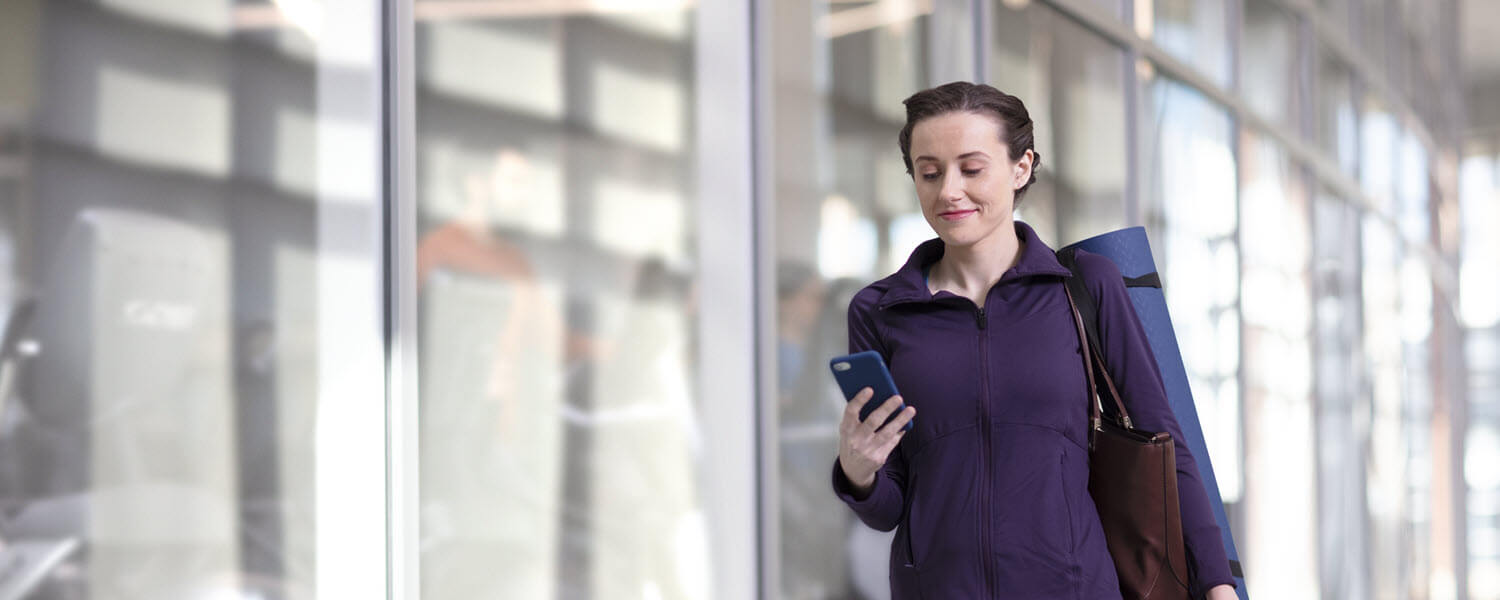 Woman walking with phone in hand